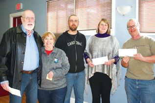 Rob Moore (centre), who organized the Polar Bear Plunge during the Frontenac Heritage Festival in February, was at Council Tuesday to, along with Mayor Frances Smith, present cheques to Ray Fletcher representing Northern Connections ($1,089.57), Maria Lockhart representing the Treasure Trunk ($1,277.67) and Isaac Hale representing the Central Frontenac Fire Department ($977.67). Photo/Craig Bakay